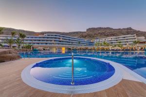 a large swimming pool in front of a hotel at Radisson Blu Resort & Spa, Gran Canaria Mogan in Puerto de Mogán