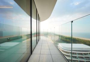 a glass building with a view of the ocean at Radisson Blu Resort Swinoujscie in Świnoujście