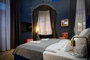 ein Schlafzimmer mit einem großen Bett und einem Fenster in der Unterkunft Noble Boutique Hotel - Adults Only in Budapest