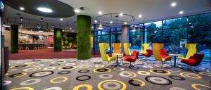 a group of chairs and tables in a lobby at Park Inn By Radisson Zalakaros Hotel & Spa in Zalakaros