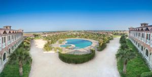 ein Luftblick auf ein Resort mit einem Pool und Palmen in der Unterkunft Radisson Blu Resort, Al Khobar Half Moon Bay in Half Moon Bay