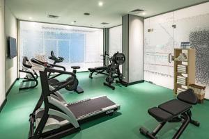 a gym with two exercise bikes and a treadmill at Park Inn by Radisson Jubail Industrial City in Al Jubail