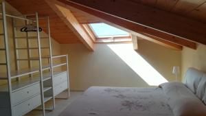 a bedroom with a loft with a bed and a window at Casa da Brunetto in Costarainera