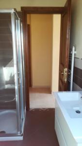 a bathroom with a glass shower door and a sink at Casa da Brunetto in Costarainera