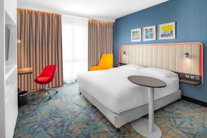a hotel room with a bed and a table and chairs at Park Inn by Radisson Jubail Industrial City in Al Jubail