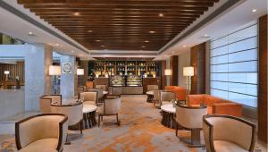 a hotel lobby with tables and chairs and a bar at Radisson Chandigarh Zirakpur in Chandīgarh