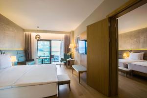 a hotel room with a bed and a living room at Radisson Blu Hotel Trabzon in Trabzon