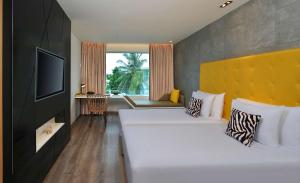 Ένα ή περισσότερα κρεβάτια σε δωμάτιο στο Radisson Bengaluru City Center