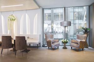 a dining room with a table and two chairs and a table and chairsktop at The Legacy Luxury Hotel, Algiers in Alger