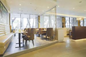 a dining room with a table and chairs at The Legacy Luxury Hotel, Algiers in Alger