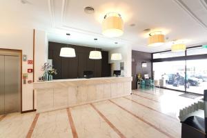a lobby with a hair salon with a mirror at Legendary Lisboa Suites in Lisbon