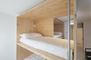 a bedroom with two bunk beds in a room at Pensión Dorotea in Lavacolla