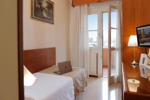 Postel nebo postele na pokoji v ubytování Hotel Michelangelo