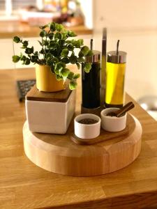 a wooden cutting board with plants on a table at The Duplex with Air Conditioning & Private Deck Area in Margate