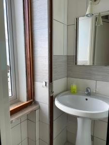 a bathroom with a white sink and a mirror at Villa belvedere in Pontecagnano