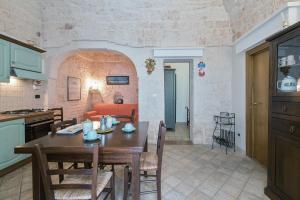 a kitchen and a dining room with a table and a living room at Civico 15 in Ostuni