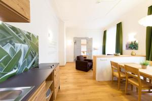 a kitchen and living room with a table and chairs at Himmlisch Urlauben Söchau in Söchau