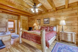 a bedroom with a bed in a log cabin at Bit O'Honey in Pigeon Forge