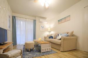 a living room with a couch and a table at Costiera Osaka Bay in Osaka +85 photos