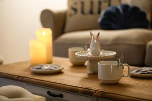 a coffee table with a candle and a tea cup on it at Costiera Osaka Bay in Osaka