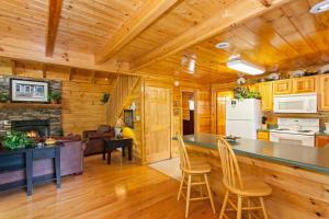 a kitchen and living room in a log cabin at A Timeless Event in Pigeon Forge