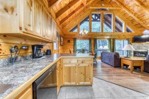 a kitchen and living room in a log cabin at Blackberry Cobbler in Pigeon Forge