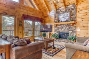 a living room with a couch and a fireplace at Heavens Scent in Pigeon Forge