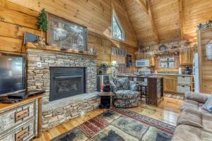 a living room with a fireplace and a tv at Pine Cone Ridge in Sevierville