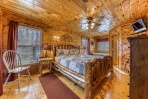 a bedroom with a bed in a log cabin at Seasons of the Heart in Gatlinburg