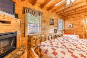 a log cabin bedroom with a bed and a fireplace at Heavens Scent in Pigeon Forge