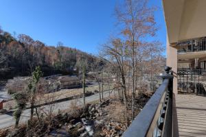 a balcony of a house with a view of a mountain at Riverside Escape & Roaring Romance in Gatlinburg