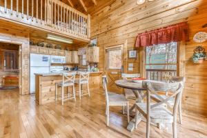 a dining room and kitchen with a table and chairs at Heavens Scent in Pigeon Forge +16 photos