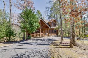 a log home in the woods with a driveway at Tennessee Treasure in Pigeon Forge