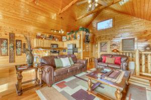 a living room with leather furniture in a log cabin at Hillbilly Highrise in Pigeon Forge
