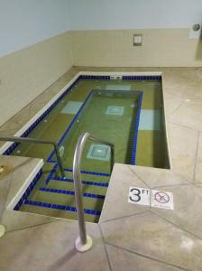 a swimming pool in the floor of a building at Northern Lights Inn in Park Falls +6 photos