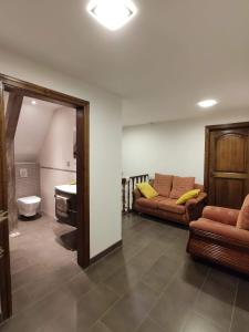 a living room with two couches and a sink at Chambre d’hotes chez Sylviane in Niederhergheim