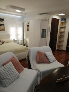 a bedroom with two beds and a table and a couch at V&M Luxury Studio in Pag