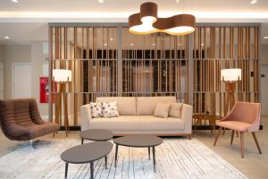 a living room with a couch and two chairs and tables at Hotel Laghetto Estação in Bento Gonçalves +32 photos
