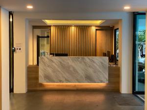 an office lobby with a large stone wall at Huahin Terminal in Hua Hin