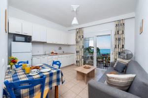 a kitchen and living room with a table and a couch at Stegna Dream in Archangelos