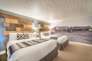 a hotel room with two beds and a wall mural at Hotel Rapids in Grand Rapids