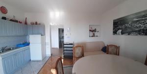 a kitchen with a table and a couch in a room at Apartments Villa Ravlić in Makarska