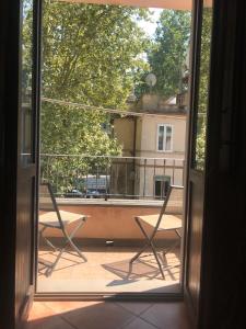 a view from a window of a balcony with two chairs at Casa della Pondi in Bagnoregio