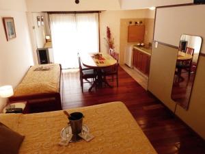 a kitchen and a living room with a table and a dining room at Apart Hotel Family in Mar del Plata