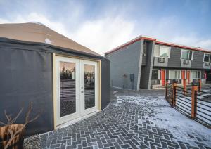 a house with a large glass door next to a building at Hotel Rapids in Grand Rapids