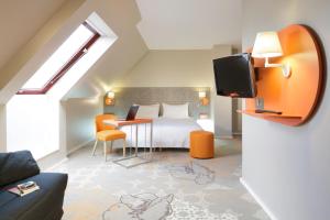 a hotel room with a bed and a tv at ibis Styles Tours Centre in Tours