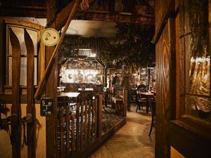 a restaurant with a clock on the wall and a table at Restaurant & Pension Rüssel - Pub in Sangerhausen