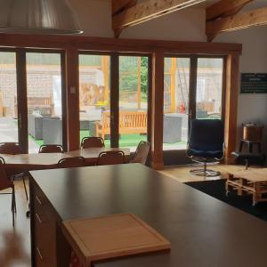 een klaslokaal met tafels en stoelen in een kamer met ramen bij LA POUDRIERE DE SAINT VENANT in Saint-Venant