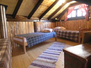 1 dormitorio con 2 camas en una cabaña de madera en Holz Haus Banja Luka, en Brda