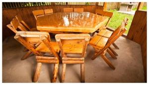 a wooden table and chairs sitting on a patio at Pensiunea Aron 2 in Bran